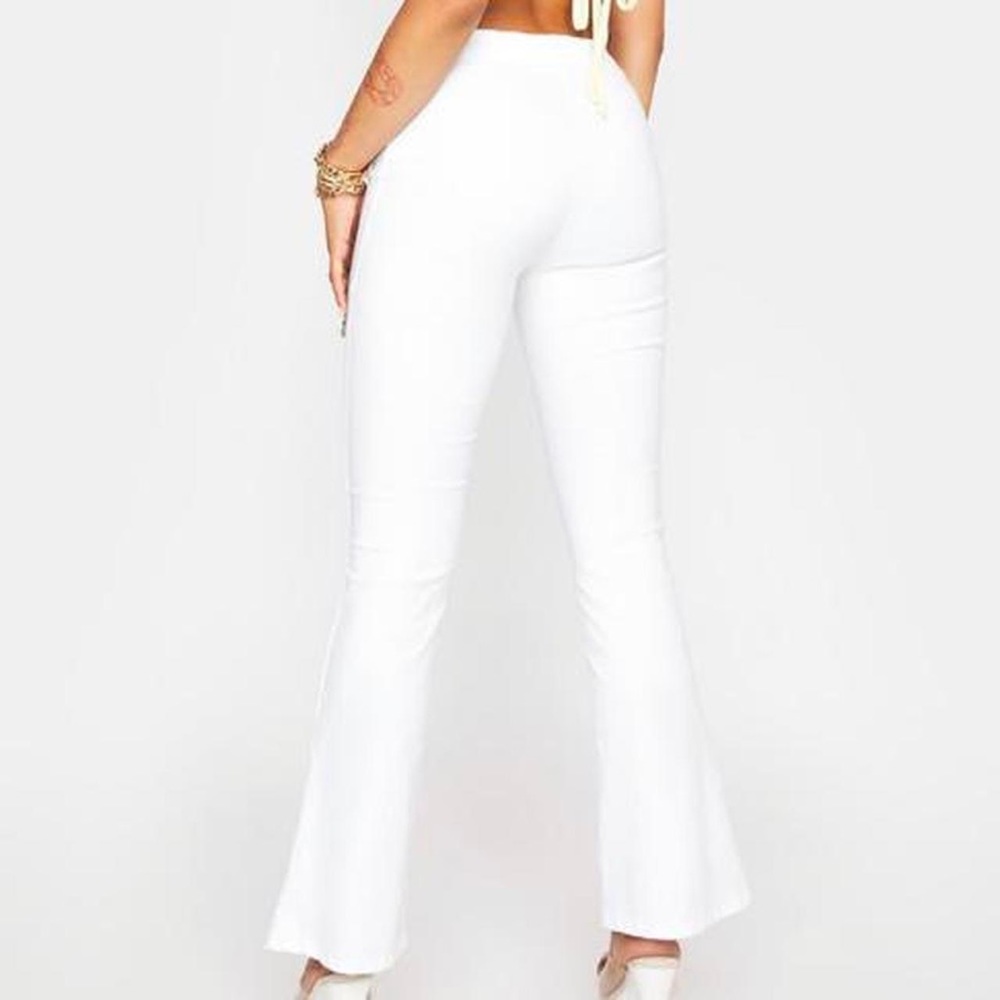 White zip-up flare pants